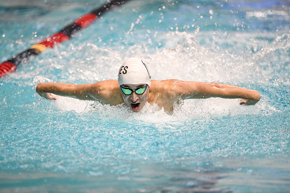 a Whitman swimmer takes a breath between strokes
