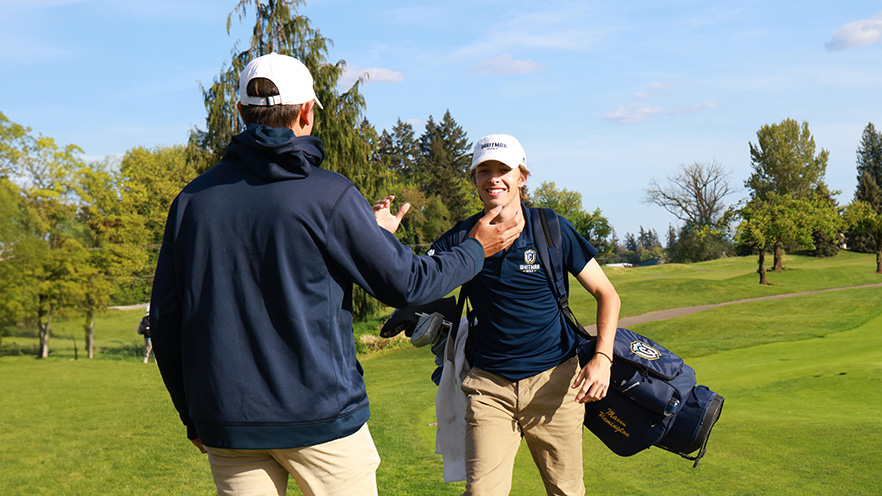 Mason Remington high-five a fellow student-athlete.