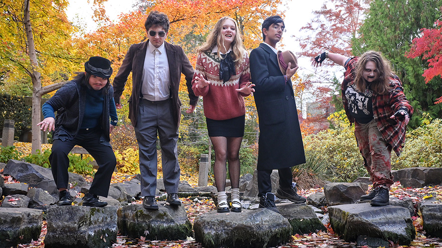 Six people standing on rocks in a stream