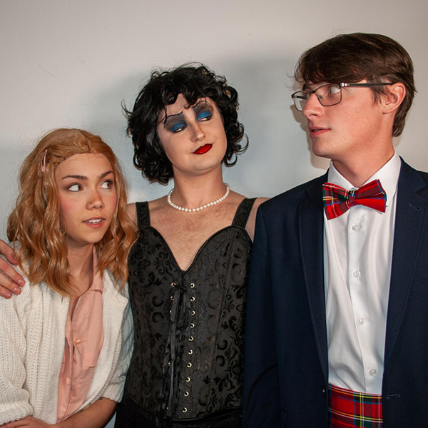 Three students dressed as Janet, Dr. Frank-N-Furter and Brad from the Rocky Horror Picture Show 