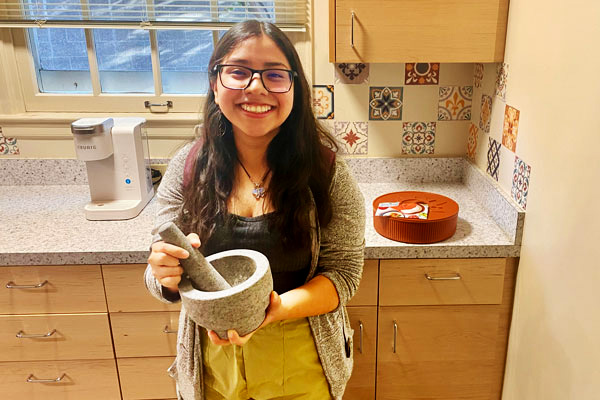 Whitman College student at the Third Space Center holding a Molcajete.