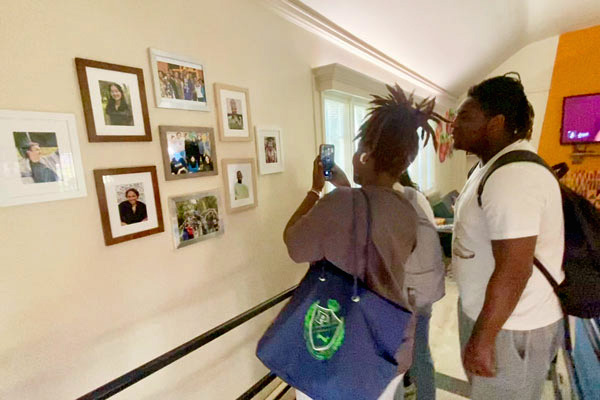 Whitman College students looking at pictures hung at the Third Space Center.