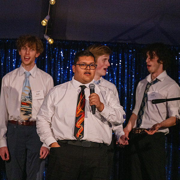 A group of a cappella singers performing on a stage