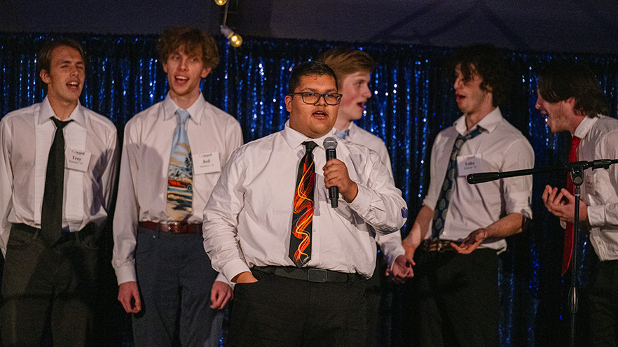 A tenor-bass a cappella group performing on a stage