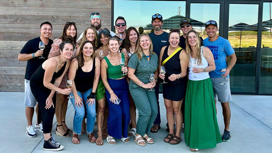 A group of people posing for a photo outside a building