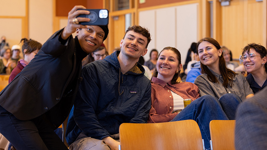 Dr. Strayhorn taking a selfie with a group of students. 