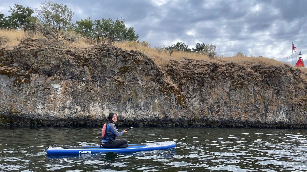 A Whitman student kayaks on the Wallula Gap during an outing with the Outdoor Program