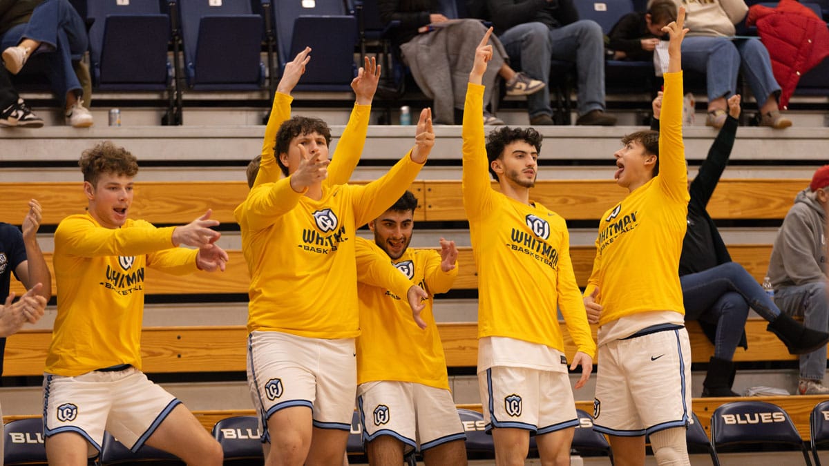 The Whitman men’s basketball team celebrates on the bench after scoring on Dec. 5 in Sherwood Center.