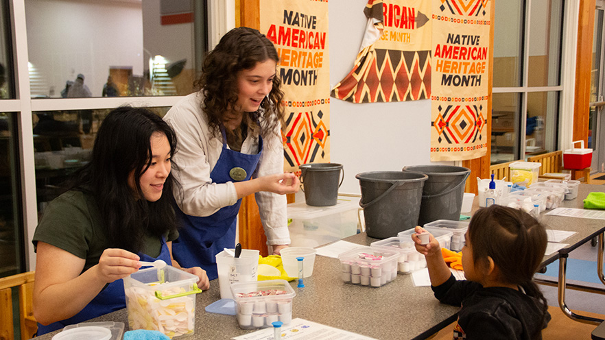 Whitman College students helping with students at the Whitman Science Night.