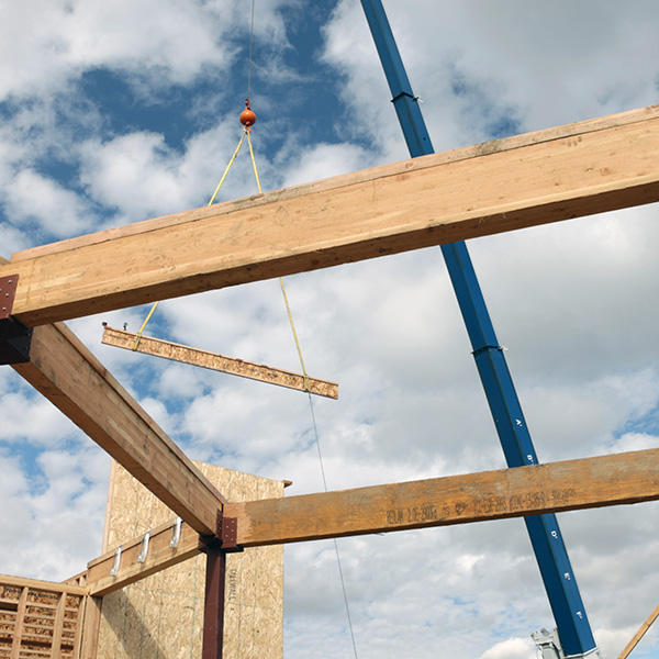 Construction of our new Stegner Hall with a beam being installed