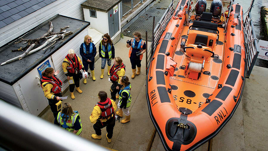 Annie Means in a boat with her crew.